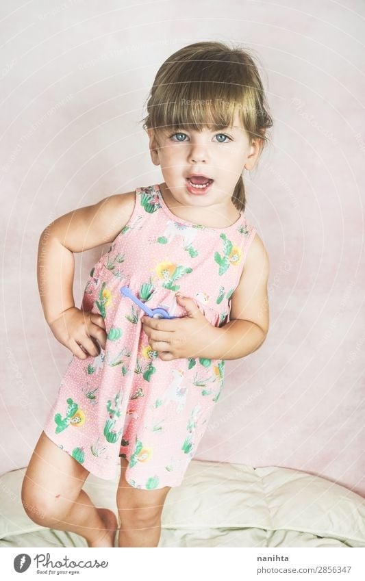 Young little and funny girl in a studio shot Lifestyle Joy Happy Face Child Human being Feminine Toddler Girl Infancy 1 1 - 3 years Fashion Dress Blonde