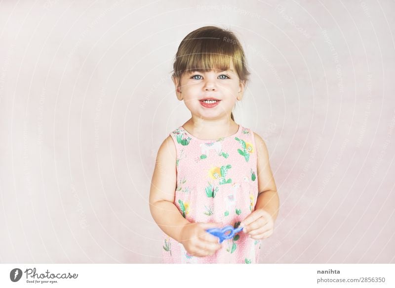 Young little and funny girl in a studio shot Lifestyle Joy Happy Face Child Human being Feminine Toddler Girl Infancy 1 1 - 3 years Dress Blonde To enjoy
