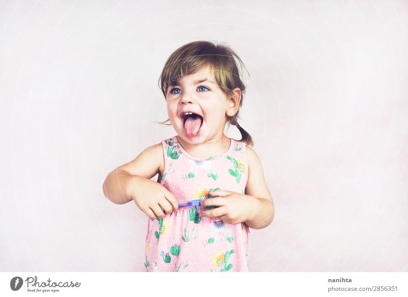 Young little and funny girl in a studio shot Lifestyle Joy Happy Face Child Human being Feminine Toddler Girl Infancy 1 1 - 3 years Dress Blonde To enjoy Brash