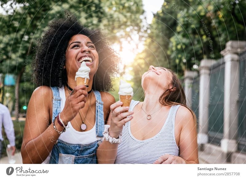 Beautiful women eating one ice cream in the street. Woman Friendship Youth (Young adults) Afro Ice cream cornet tasting Eating Cream Happy Summer