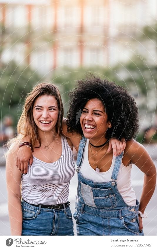Beautiful women having fun in the street. Woman Friendship Youth (Young adults) Happy Summer Portrait photograph Human being Joy Smiling Walking Racism Adults