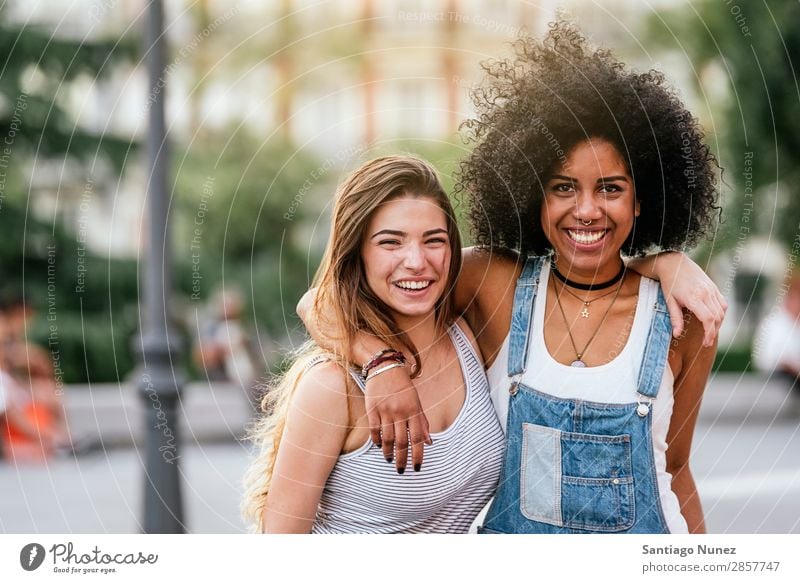 Beautiful women having fun in the street. Woman Friendship Youth (Young adults) Happy Summer Portrait photograph Human being Joy Smiling Walking Racism Adults