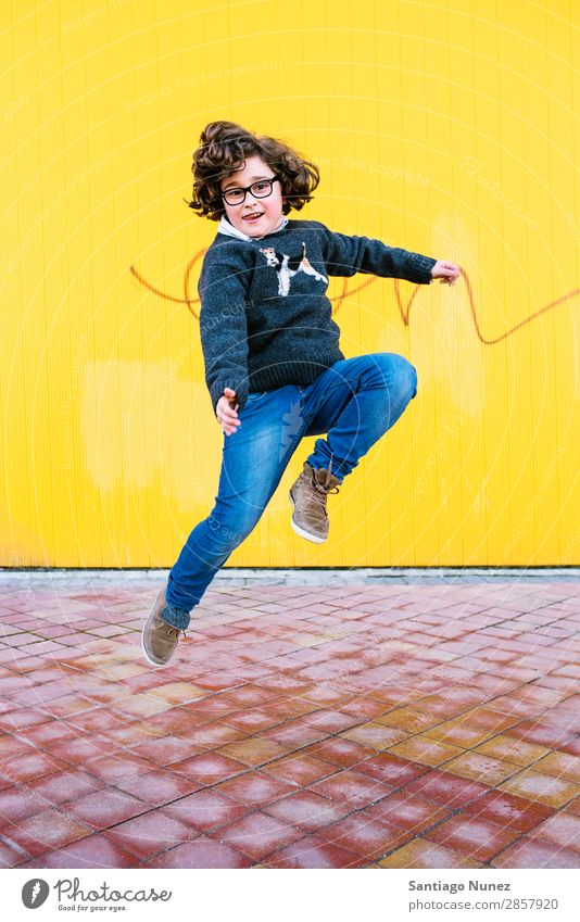 Happy boy jumping. Jump Boy (child) Child Excitement Style Youth (Young adults) Street Town Freestyle Background picture City Man Model Lifestyle Exterior shot