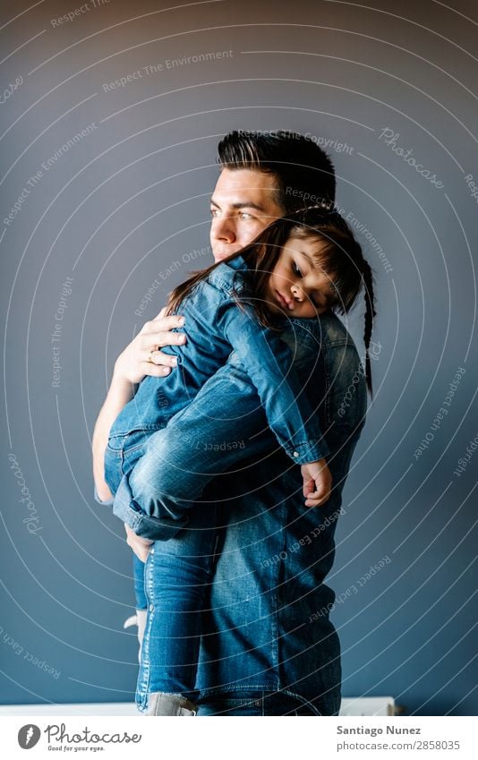 Proud father hugs his daughter. Father Baby Day Happy Considerate Embrace hugging dad Youth (Young adults) Portrait photograph Girl Daughter Child Pride Small