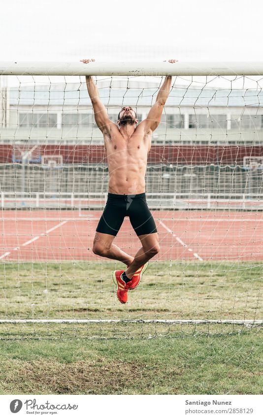 Man Doing Chin-ups outdoor. abs Action Athlete Attractive chin-up Practice Athletic Fitness Green Gymnasium handsome Healthy Horizontal instructor Lifestyle