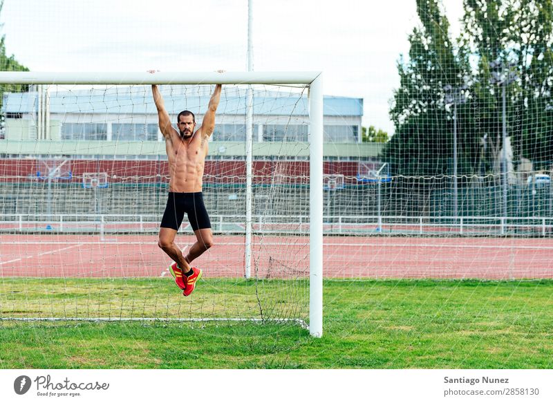 Man Doing Chin-ups outdoor. abs Action Athlete Attractive chin-up Practice Athletic Fitness goalpost Green Gymnasium handsome Healthy Horizontal instructor