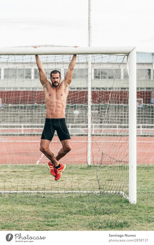Man Doing Chin-ups outdoor. abs Action Athlete Attractive chin-up Practice Athletic Fitness goalpost Green Gymnasium handsome Healthy Horizontal instructor