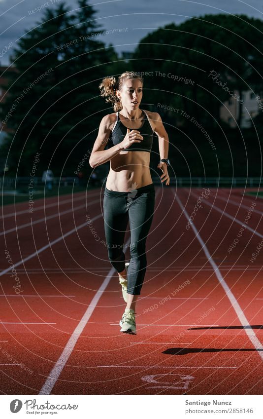 Attractive woman Track Athlete Running On Track Action athleticism cacucasian challenge Competition Self-confident Determination Practice Woman finishing