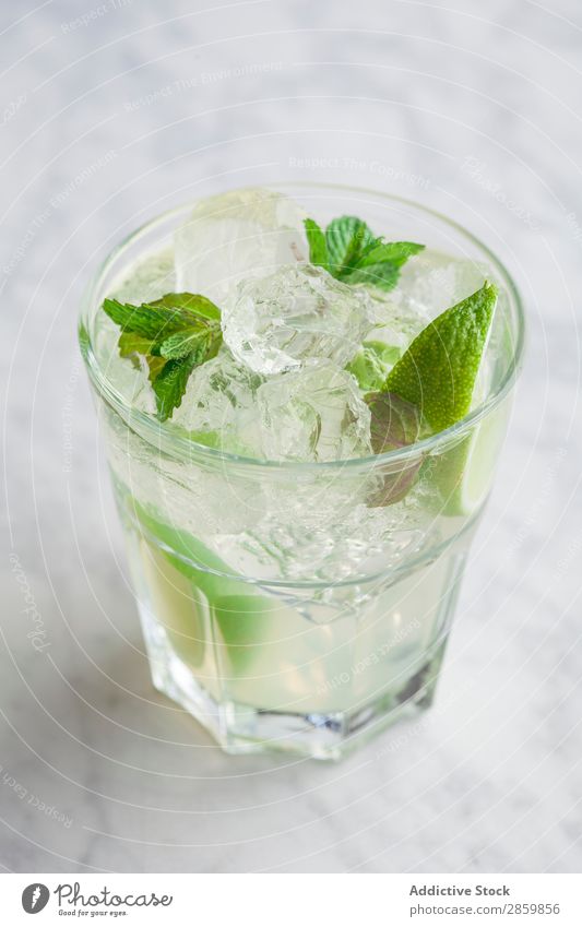 Glass of mojito with rum, lime and mint Alcoholic drinks barman bartender Beverage Cocktail Cold Drinking Fresh garnish Gin Ice Juice Lemon Lime Mint mixologist