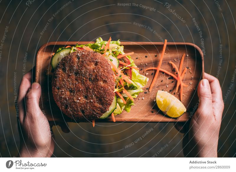 Woman holding a tray with a Vegetarian sandwich Avocado bio Bread Roll burger Carrot Cucumber Delicious Deluxe Diet eco Ecological Food Fresh Bird's-eye view