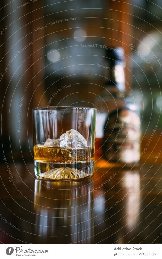Glass of whiskey on the rocks Alcoholic drinks Amber Background picture Bar barman bartender Beverage Bottle Bourbon Brandy Cognac Day Drinking Gold Ice