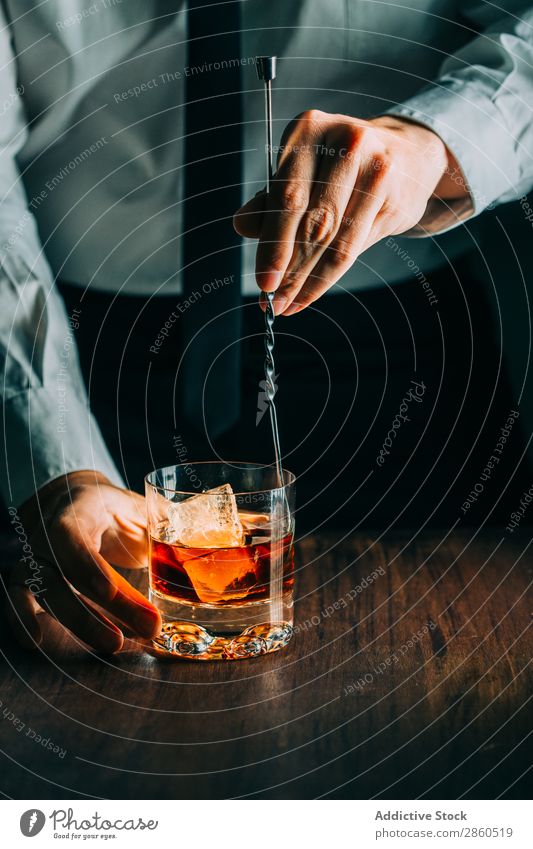 Glass of whiskey on a wooden table Alcoholic drinks Amber Background picture Bar barman bartender Beverage Bottle Bourbon Brandy Cognac Drinking Gold Hand Ice