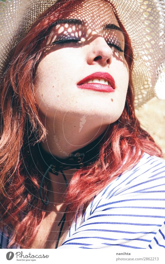 Redhead model protecting herself from sun Lifestyle Elegant Style Beautiful Skin Face Cosmetics Healthy Health care Wellness Senses Relaxation Vacation & Travel
