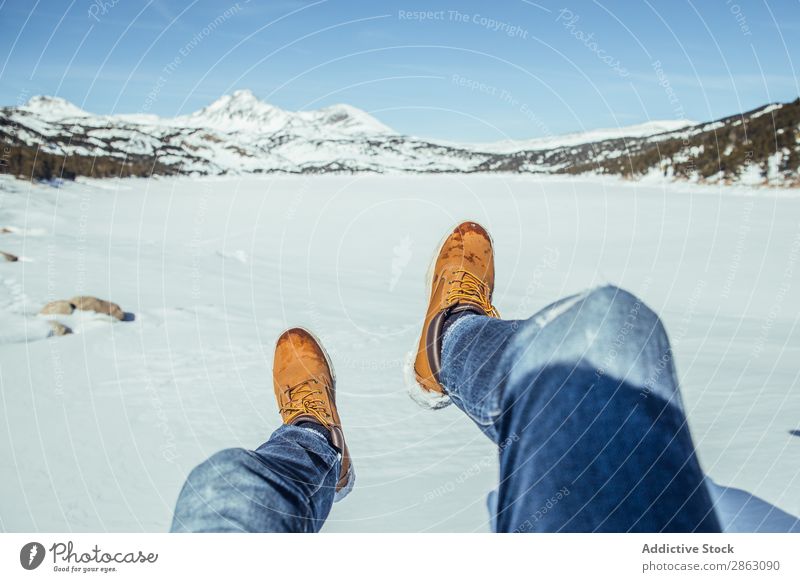 Man legs in winter boots on snow near mountains Boots Snow Winter Mountain cerdanya France Legs Jeans Beautiful weather Hill Sit Easygoing Warmth Comfortable