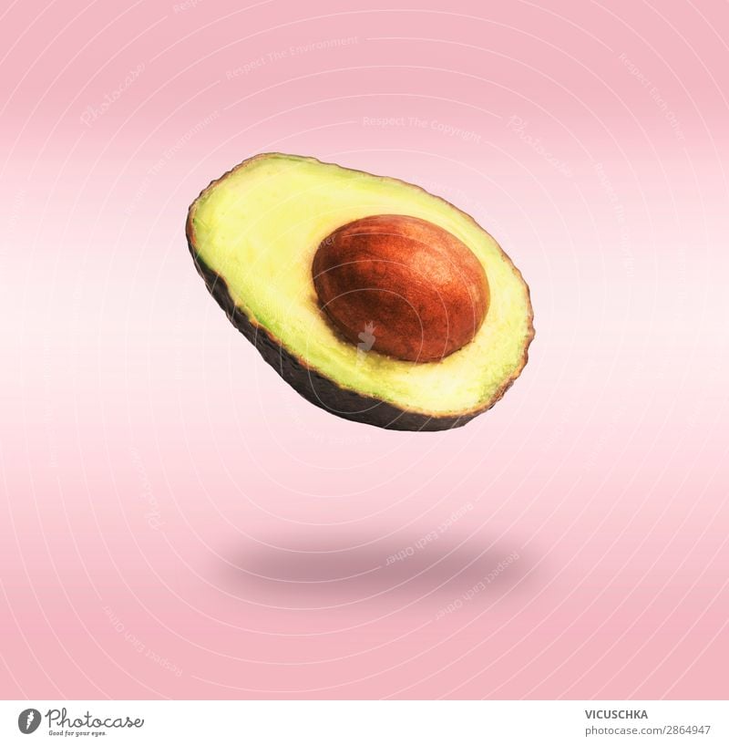 Flying half avocado on pink background Food Vegetable Nutrition Organic produce Vegetarian diet Diet Lifestyle Shopping Design Healthy Eating Pink Style
