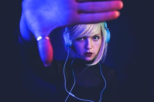Young woman listening to music Lifestyle Beautiful Hair and hairstyles Face Night life Music Disc jockey Headset Technology Entertainment electronics