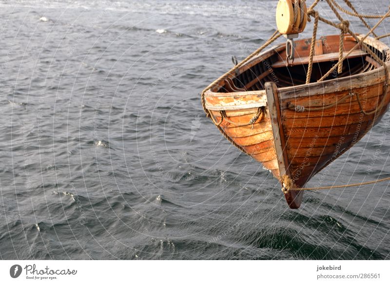 floating state Aquatics Rowboat Watercraft Waves Hang Gray Rope Pulley Colour photo Exterior shot Deserted Copy Space left Copy Space bottom Isolated Image