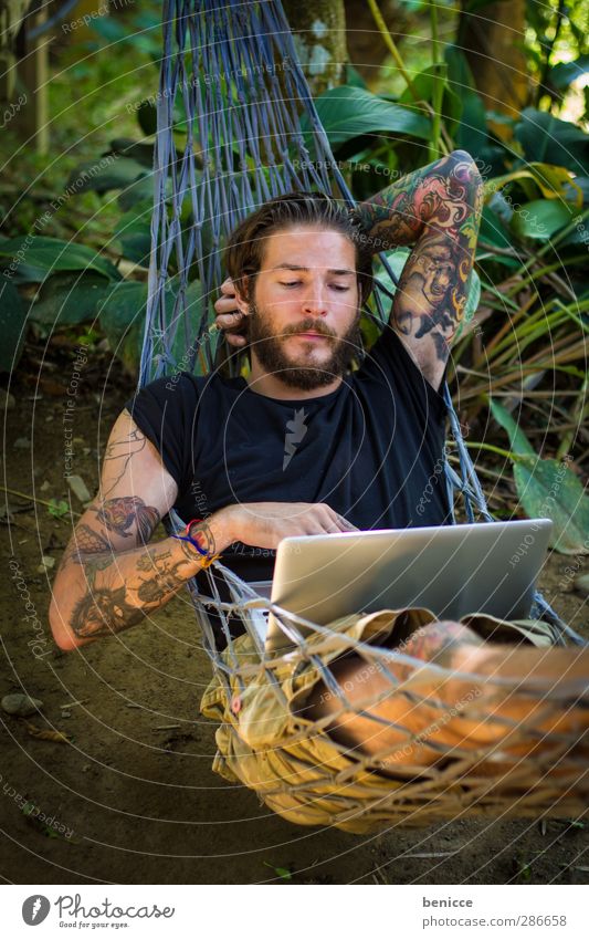 hang out Man Human being Youth (Young adults) Young man Hammock Lie Computer Notebook Calm Motionless Work and employment Tattoo Tattooed Facial hair Beard