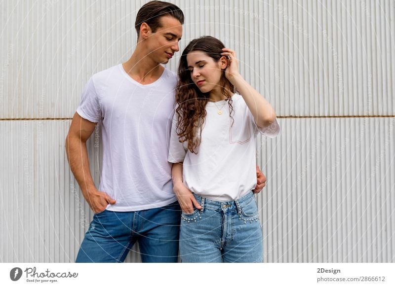 Beautiful young couple hugging, looking at camera and smiling Style Joy Happy Summer Flirt Human being Woman Adults Man Couple 2 18 - 30 years