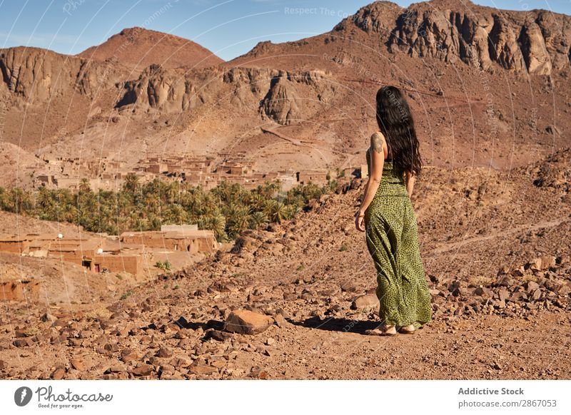 Woman between desert near mountains Desert Mountain Marrakesh Morocco Construction Landing Lady Youth (Young adults) Hill Brunette Ancient Old Building