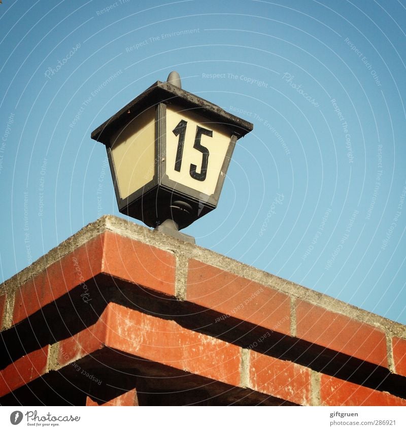 15 House (Residential Structure) Blue Digits and numbers Characters Symbols and metaphors House number Wall (barrier) Brick Brick red Brick construction Lantern