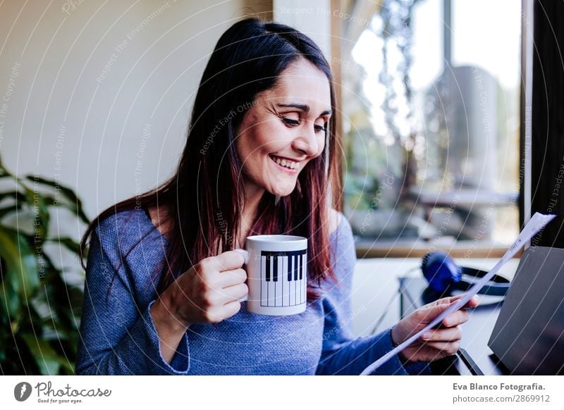 young woman holding a cup of coffee at home Coffee Style Beautiful Leisure and hobbies Playing Music Human being Feminine Young woman Youth (Young adults) Woman