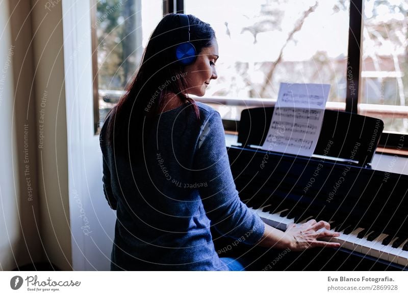 young woman holding playing piano at home Coffee Style Beautiful Leisure and hobbies Playing Music Human being Feminine Young woman Youth (Young adults) Woman