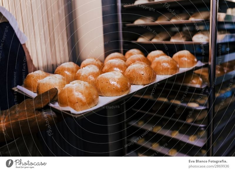 woman holding rack of rolls in a bakery. Bread Happy Kitchen Restaurant School Work and employment Profession Camera Feminine Woman Adults Hand 1 Human being