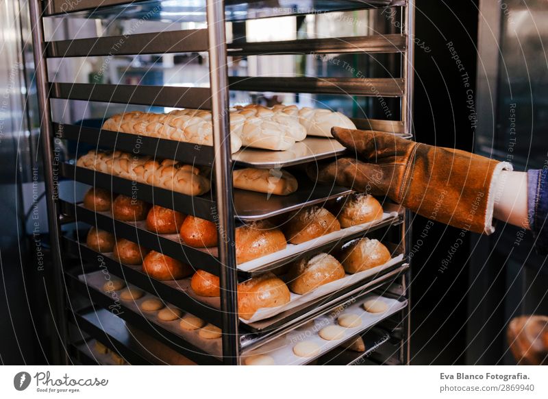 woman holding rack of rolls in a bakery Bread Happy Kitchen Restaurant School Work and employment Profession Camera Feminine Woman Adults Hand 1 Human being