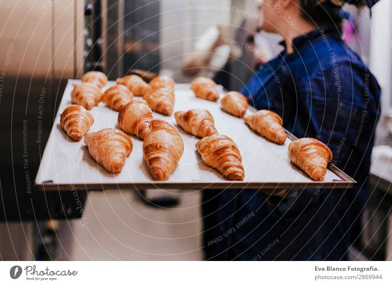 woman holding holding rack of croissants in a bakery Bread Happy Kitchen Restaurant School Work and employment Profession Camera Feminine Woman Adults 1