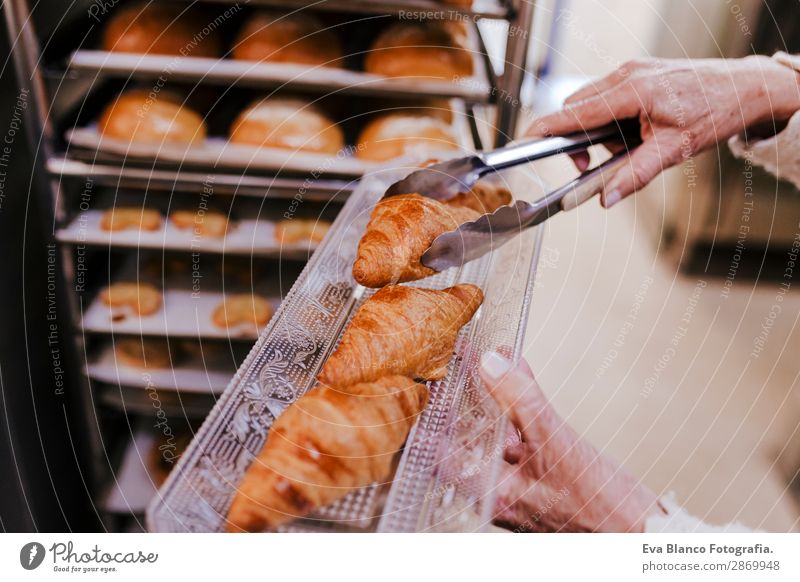 woman holding holding rack of croissants Bread Happy Kitchen Restaurant School Work and employment Profession Camera Feminine Woman Adults 1 Human being