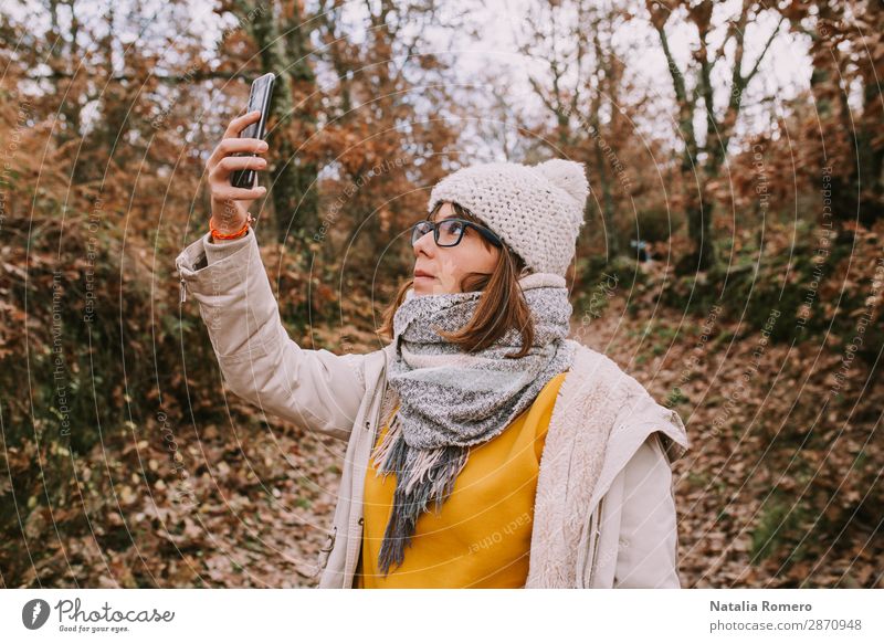 a young woman looks at the mobile phone in the forest Lifestyle Beautiful Vacation & Travel Adventure Hiking Telephone Screen Technology Human being Woman