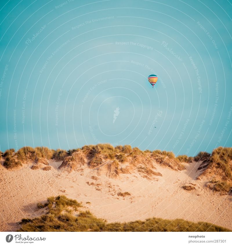 Around the world in 80 days Sand Sky Coast Blue Yellow Gold Beach Dune Hot Air Balloon Aviation Hover Square Wind Travel photography Colour photo Exterior shot