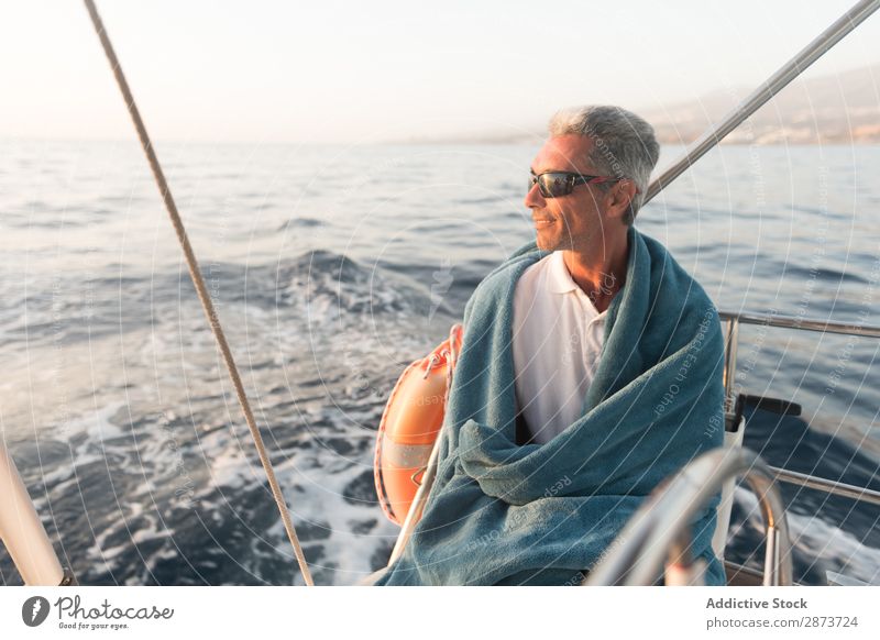 Smiling man in towel on yacht on water Man Yacht Water Adults Ocean Floating Towel Beautiful weather Watercraft Expensive Sunglasses Resting Positive Summer Sit