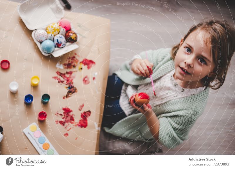 Girl with brush coloring chicken eggs at table in room Easter Egg Brush Room Sofa Colouring Funny Child Table Chicken Container Painting and drawing (object)