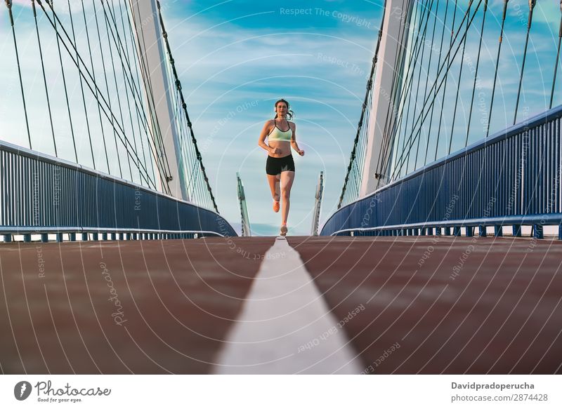 Young fit blonde woman running on the bridge Woman Running Practice Fitness work out Lifestyle Movement Action Jogging Bridge Horizontal Athletic Healthy