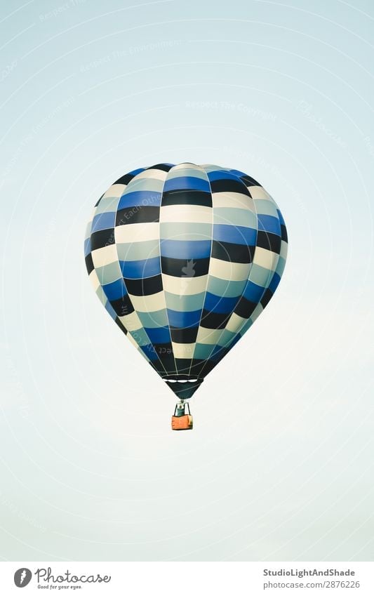 Blue hot air balloon in the clear sky Joy Leisure and hobbies Vacation & Travel Adventure Freedom Sports Sky Transport Aircraft Hot Air Balloon Old Flying Faded