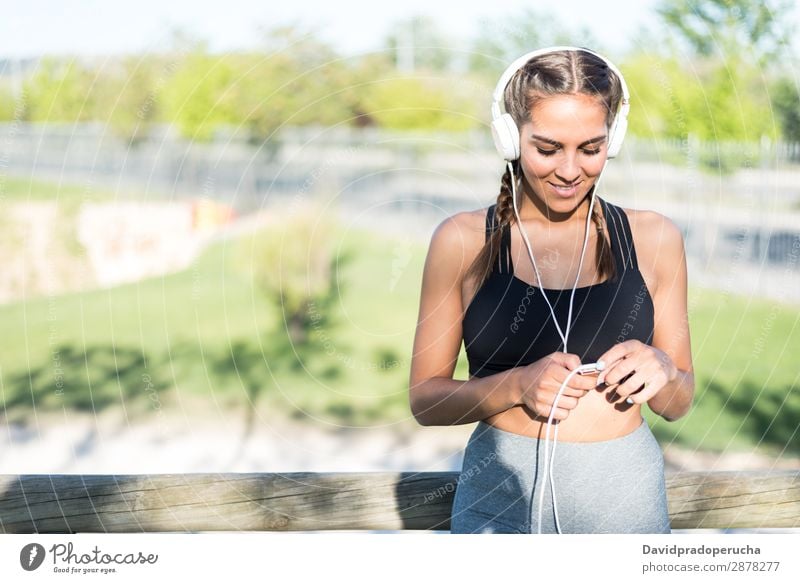 close up portrait of a woman doing sport resting outdoor smiling and listening music jogging sports woman run running fitness stretching exercise girl young