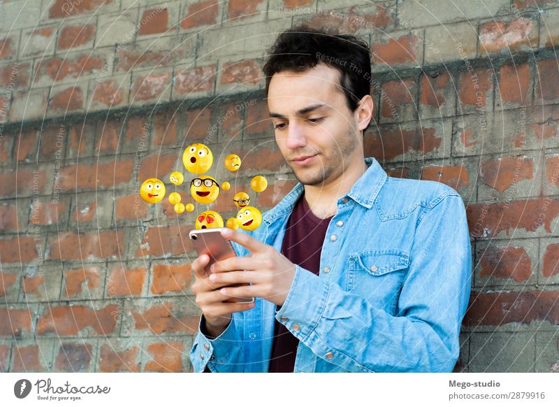Man using smartphone sending emojis Lifestyle Happy Face Telephone PDA Screen Technology Internet Human being Adults Hand Funny Modern Smart Emotions young