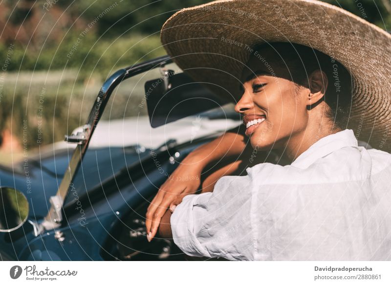 Black woman driving a vintage convertible car Woman Car Driving Ethnic Happy Convertible Street Luxury Looking away Cheerful Smiling Classic 60's Beautiful