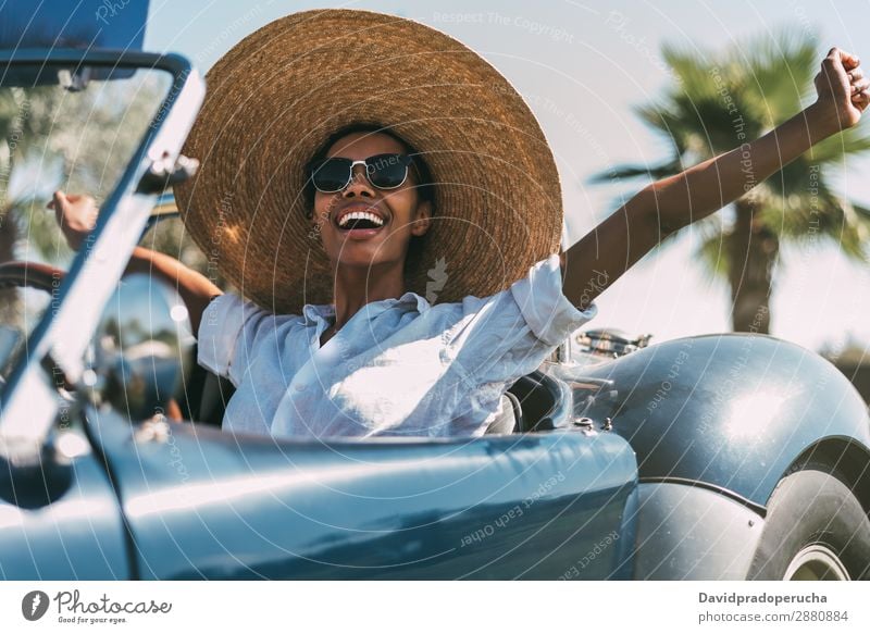 Black woman driving a vintage convertible car Woman Car Driving Ethnic Convertible Transport Street Luxury Looking away Cheerful Happy Smiling Vintage Classic
