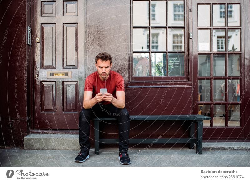 Man sitting in a bench on a beautiful maroon background Cellphone Caucasian Building Youth (Young adults) Architecture Technology Vintage Notting Hill decor