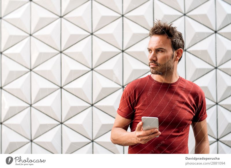 Man with mobile phone Cellphone Architecture Caucasian PDA Geometry Portrait photograph Background picture Technology Youth (Young adults) Future Building