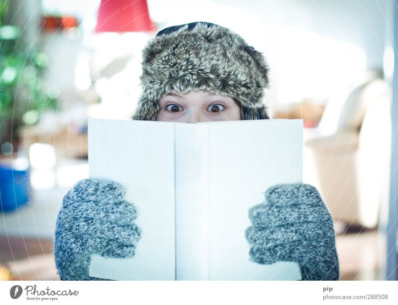 winter reading Reading Human being Boy (child) Young man Youth (Young adults) Eyes Hand Fingers 1 Gloves Cap Fur hat Observe Study Looking Bright Book