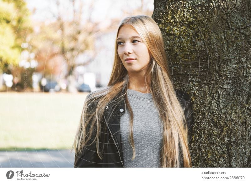 dreamy young woman leaning against a tree Lifestyle Leisure and hobbies Human being Feminine Young woman Youth (Young adults) Woman Adults 1 13 - 18 years