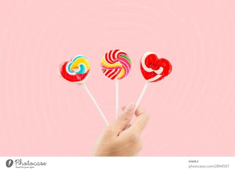 Woman hand holding three colorful lollipops Food Dessert Candy Style Joy Adults Hand Heart Love Bright Delicious Retro Pink Red White Colour Gift Lollipop