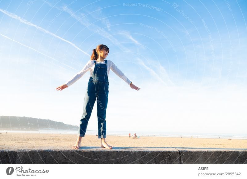 Little girl feeling free on the beach Joy Happy Beautiful Playing Vacation & Travel Freedom Summer Beach Ocean Child Arm Nature Sand Sky Coast Jeans Brunette