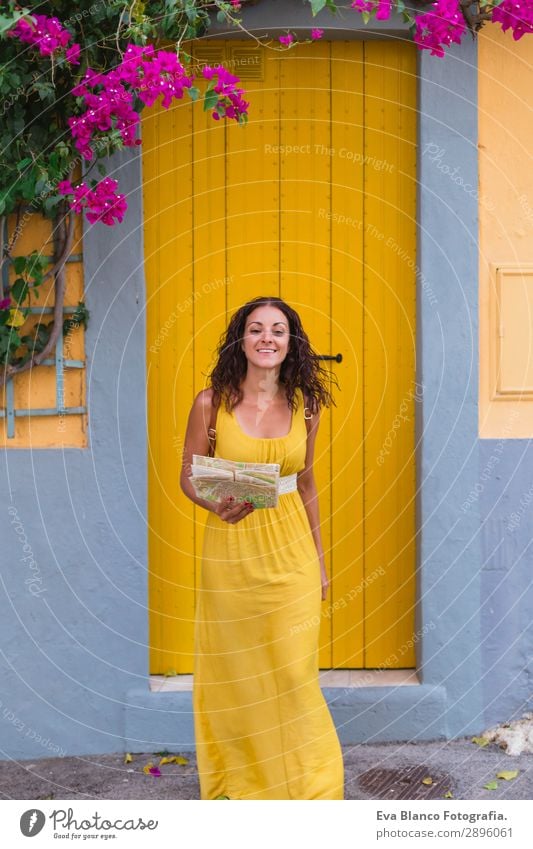 Young tourist woman in yellow dress smiling and looking a map Happy Vacation & Travel Tourism Trip Sightseeing Telephone Human being Young woman