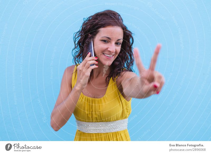 Young beautiful woman in yellow dress using mobile phone Lifestyle Happy Beautiful Body Vacation & Travel Summer To talk Cellphone Technology Internet
