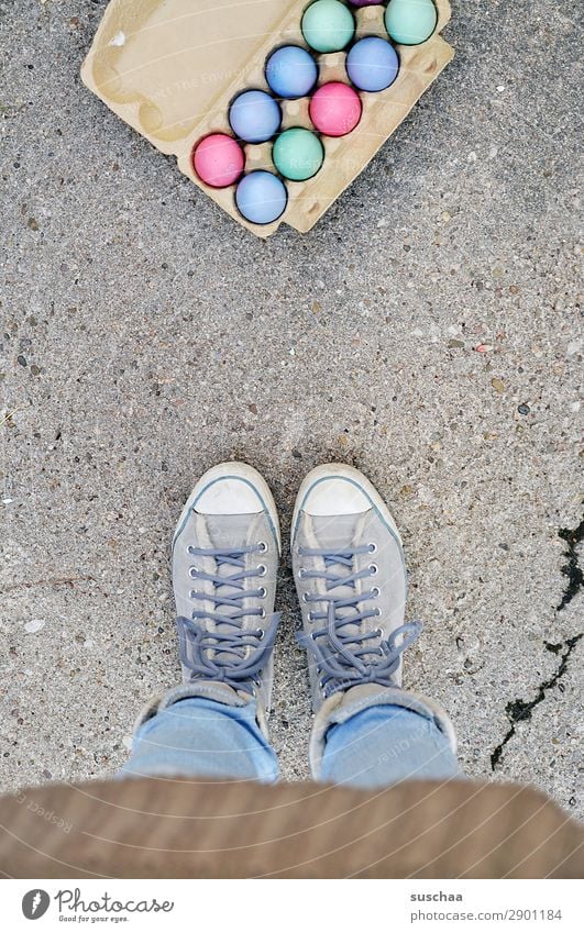 Easter eggs Woman Human being Legs Feet Egg Eggs cardboard Feasts & Celebrations Tradition Multicoloured Colour Stand Street Asphalt Footwear lace-up shoes